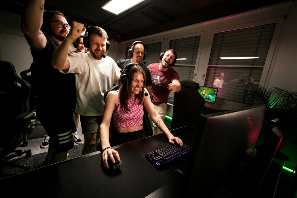 A group of people standing around a computer